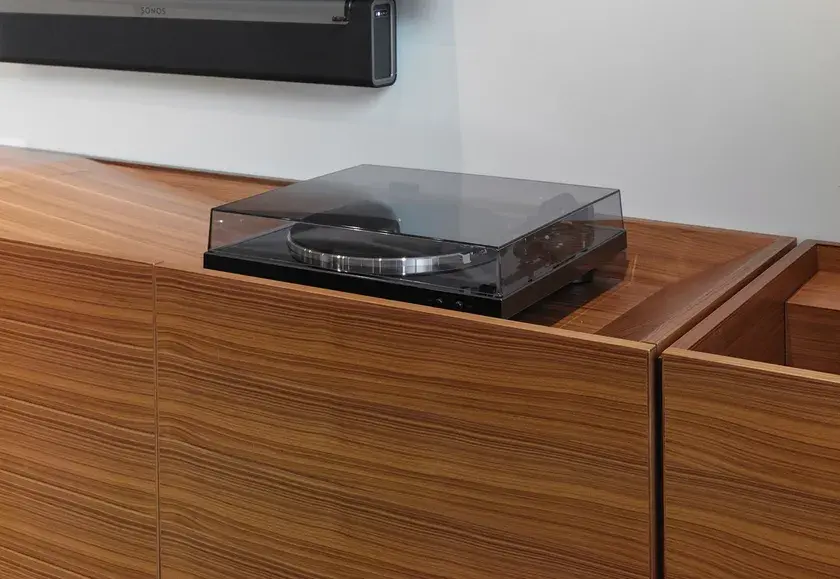 close up of a custom walnut millwork credenza with a turntable